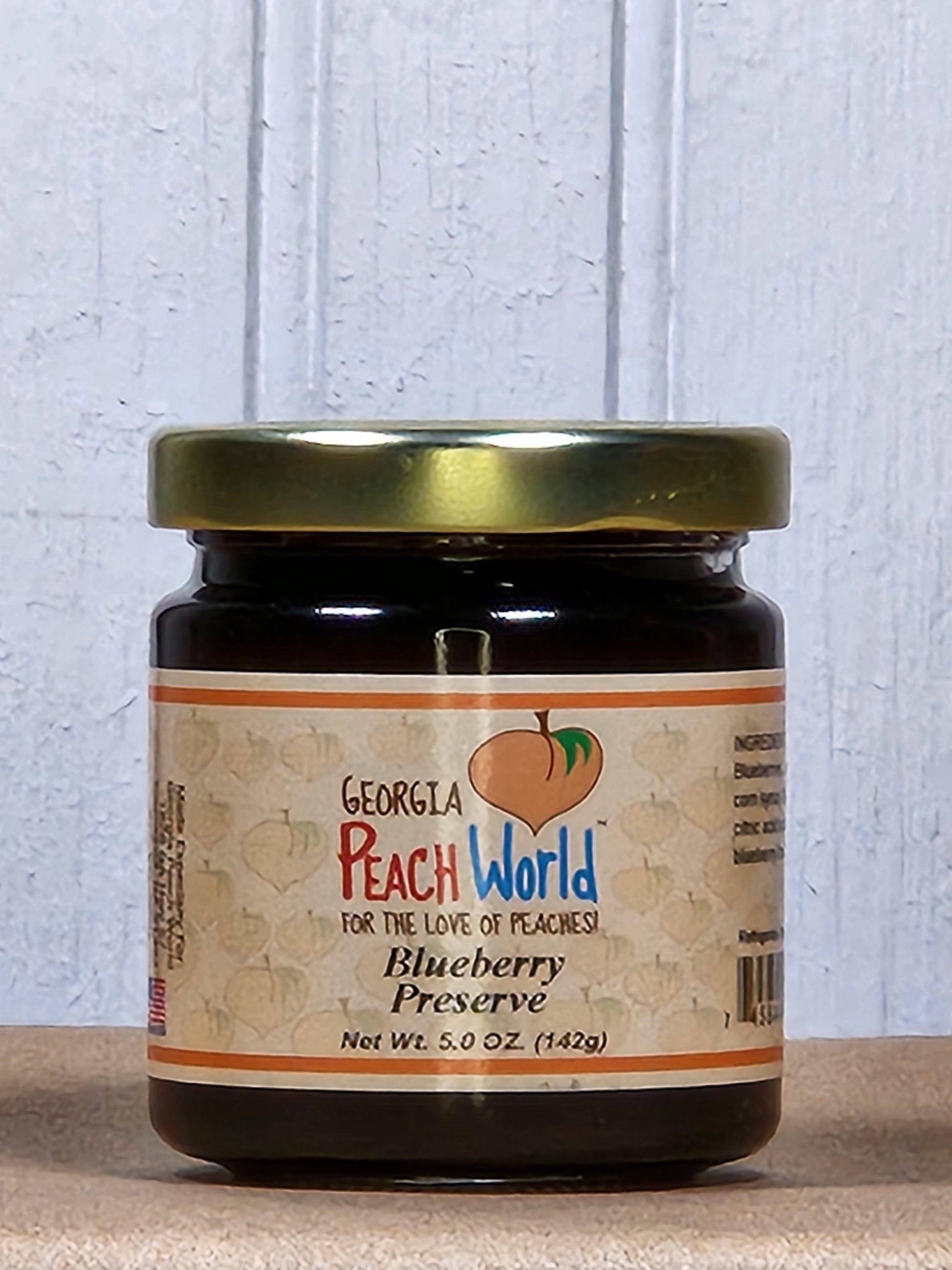 5oz jar of Georgia Peach World blueberry preserve, a rich and fruity spread in a glass jar, ideal for breakfast or snacks.