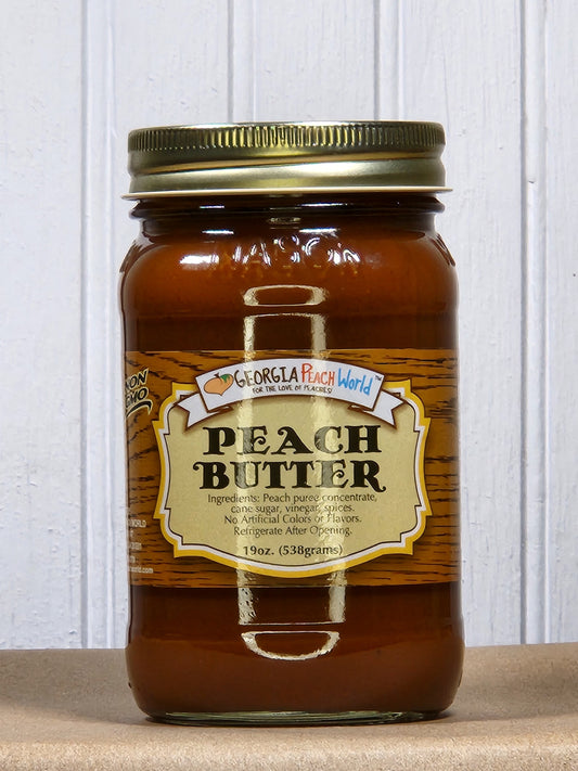 Jar of Georgia Peach World peach butter jam with golden peach spread on a white background