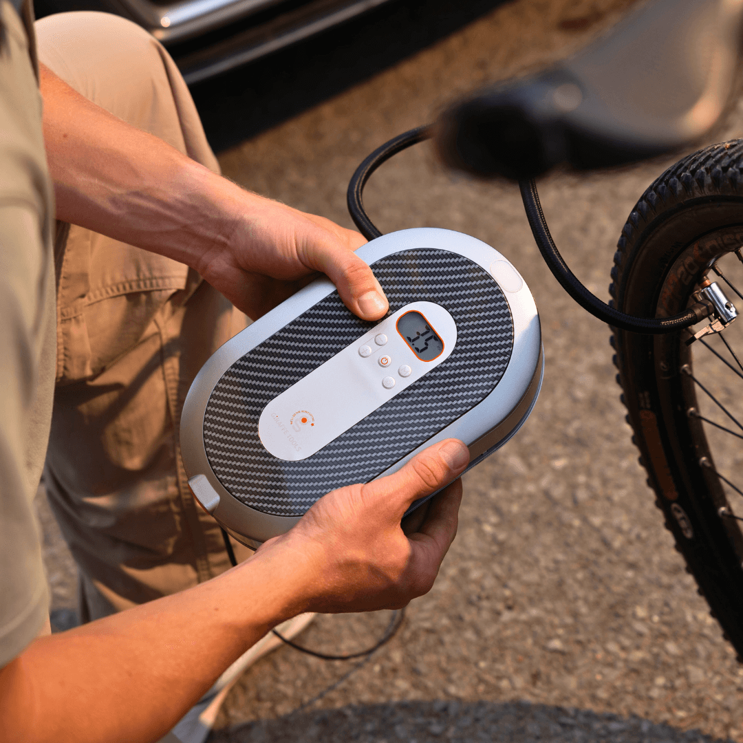 Giraffe Tools US retractable car tire inflator with compact design and flexible hose for easy air filling.