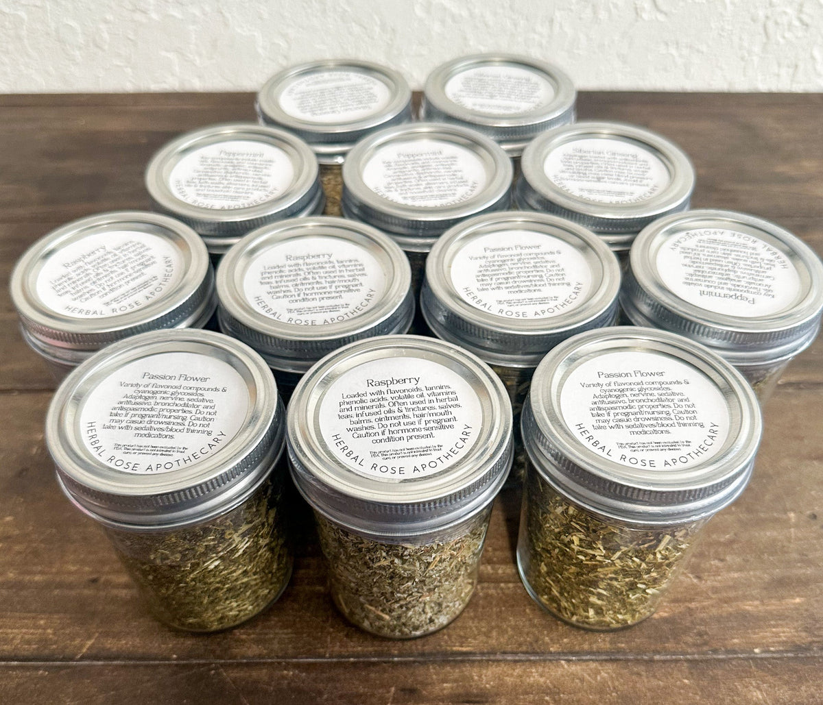 Set of small glass herb jars from HerbalRoseApothecary filled with dried herbs, perfect for storing herbs and spices.