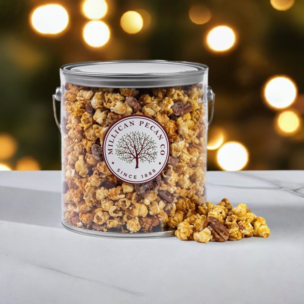 Millican Pecan Caramel Pecan Popcorn in a 1-gallon pail, featuring caramel-coated popcorn with pecans, a delicious pecan treat.