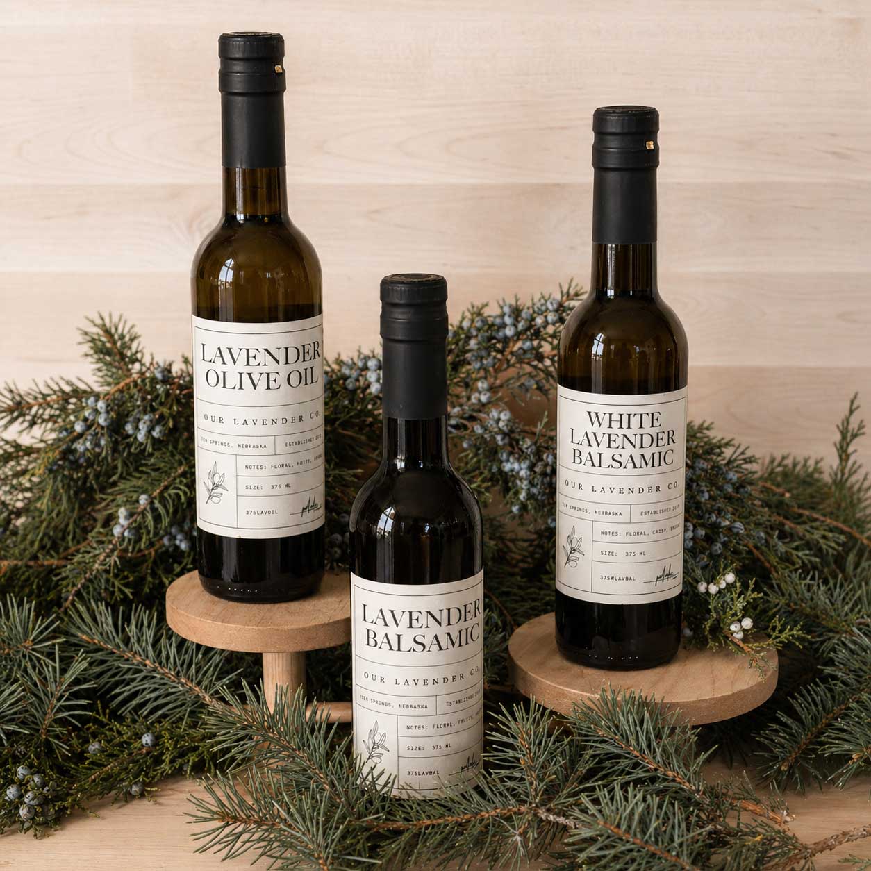 Lavender-infused olive oil in a clear glass bottle with a lavender sprig, showcasing the aromatic food product from Our Lavender Co.