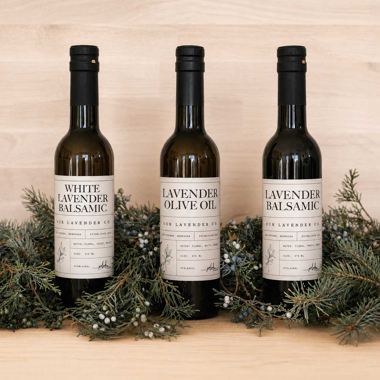 White lavender balsamic vinegar bottle from Our Lavender Co, 12.7 oz, with fresh lavender sprigs and a clear glass bottle.