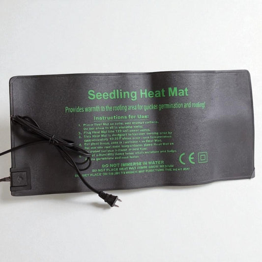 Hasty Roots seedling heat mat for gardening, showing a black mat with control cord, used to warm seedlings for healthy growth.
