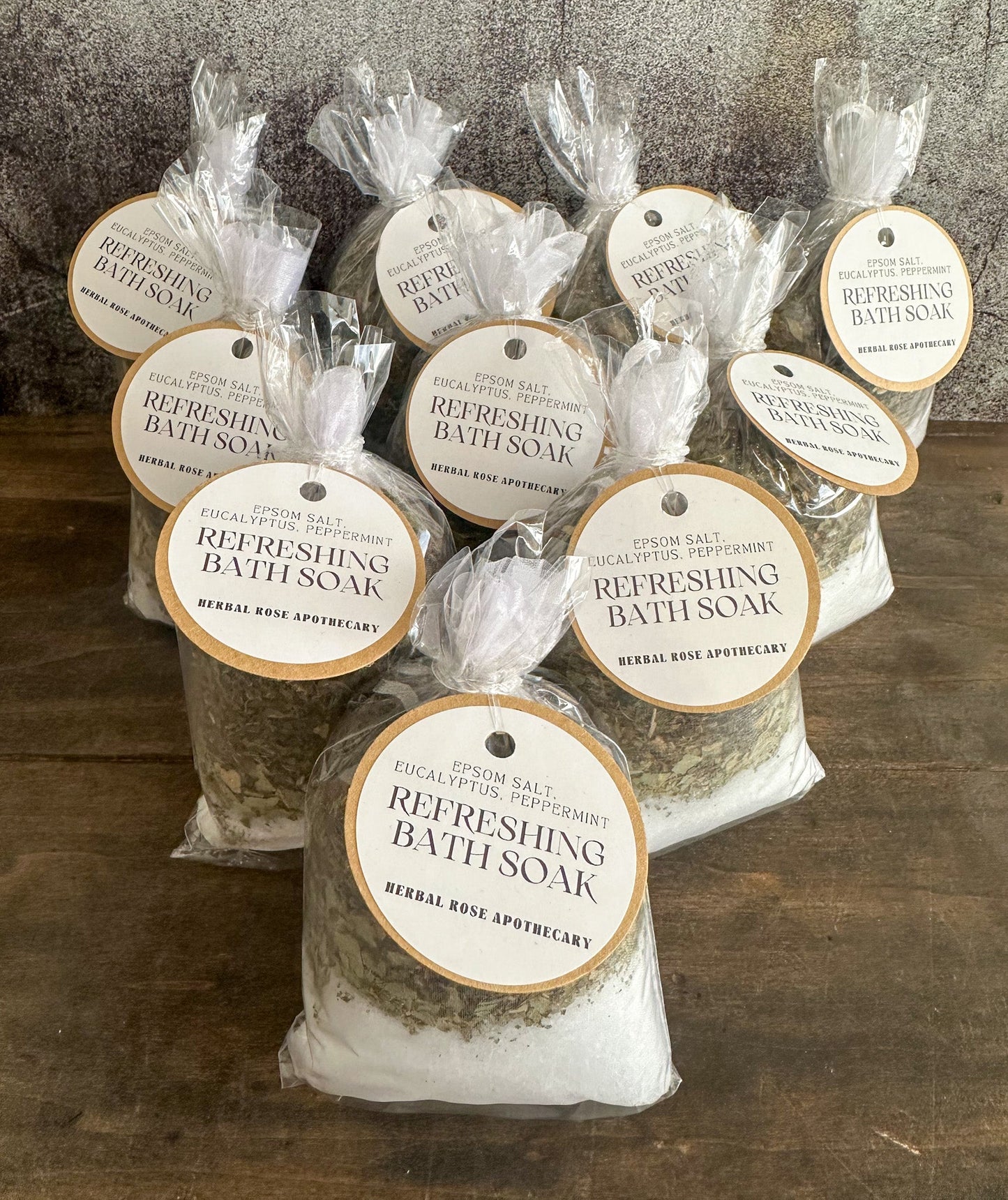 Herbalroseapothecary sore muscle herbal bath soak with Epsom salts, peppermint, and dried roses in a glass jar.