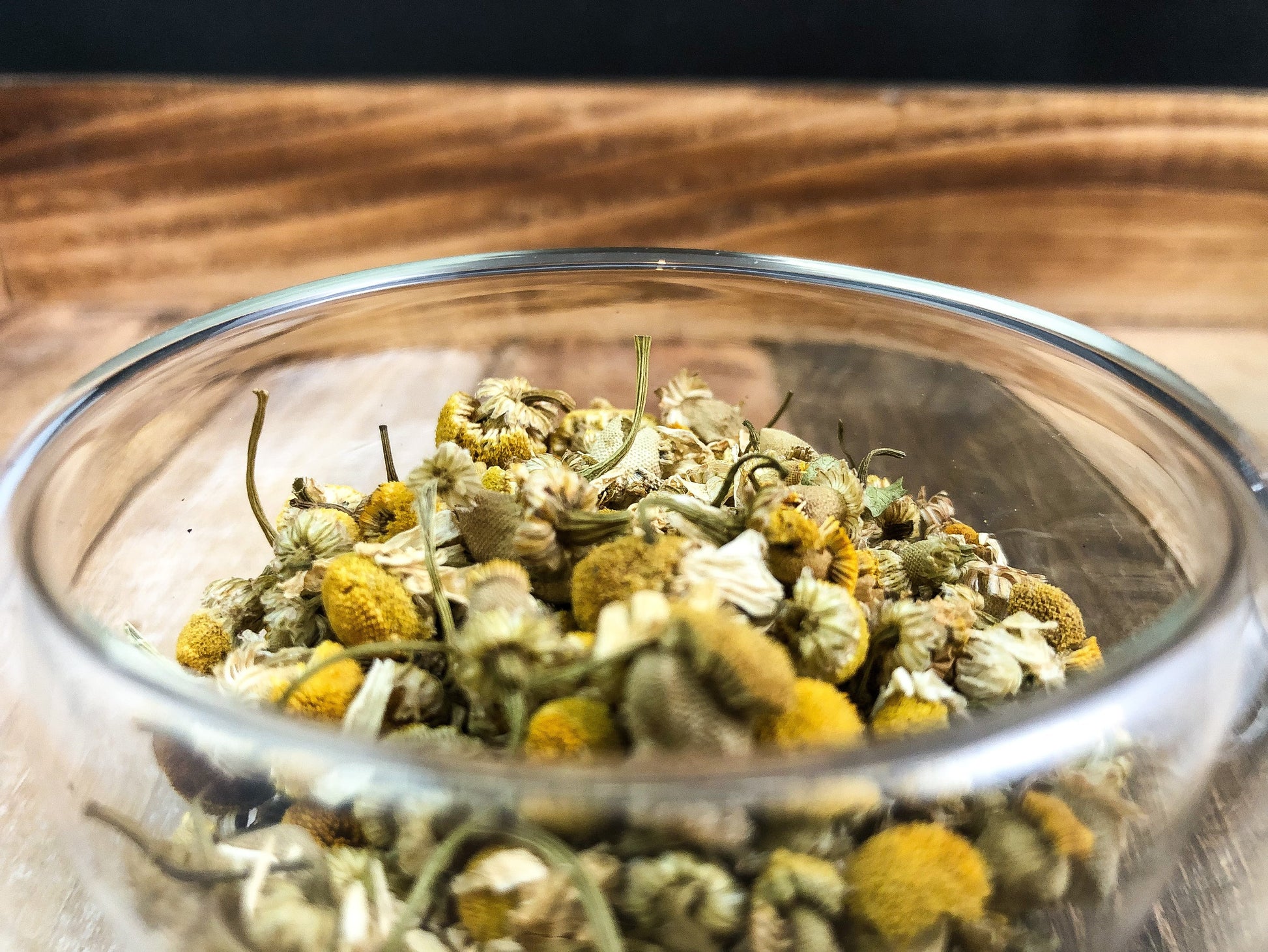 Dried organic chamomile herbs in an 8g package from HerbalRoseApothecary, showing golden chamomile flowers and leaves.