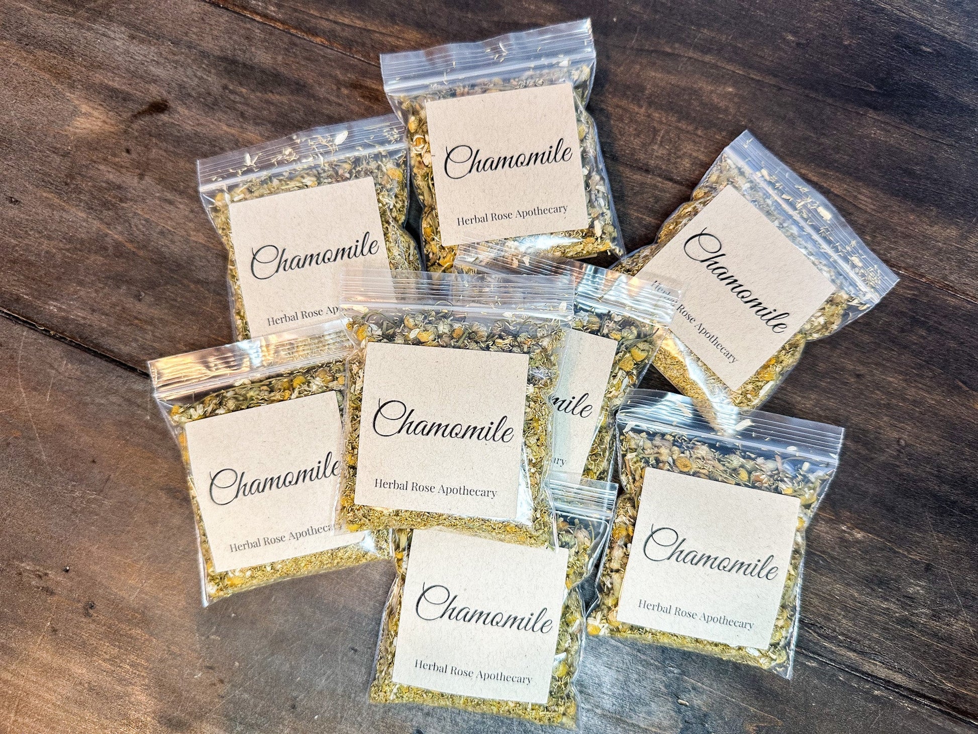 Dried organic chamomile herbs in an 8g package by Herbal Rose Apothecary, showing golden chamomile flowers and leaves.