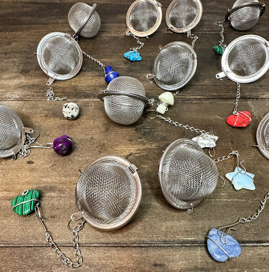 Herbalroseapothecary tea ball infuser with stainless steel mesh for steeping loose leaf teas in cups or teapots.