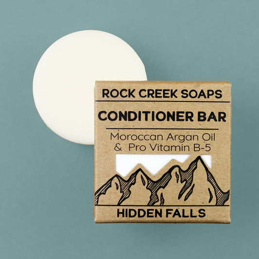Colorful conditioner bar from Rock Creek Soaps with argan oil, designed for nourishing hair in a compact, eco-friendly package.