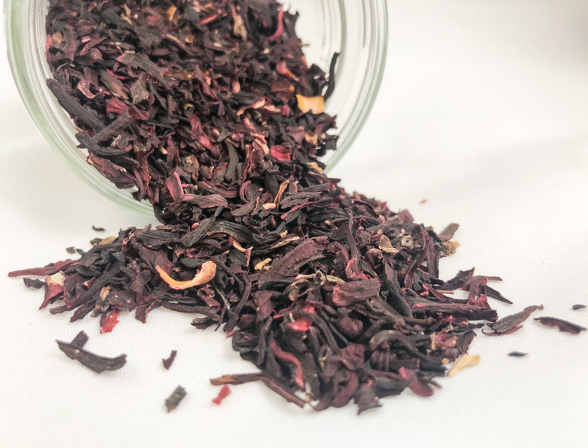 Small herbal jars from HerbalRoseApothecary with dried hibiscus herbs in white jars for herbal storage.
