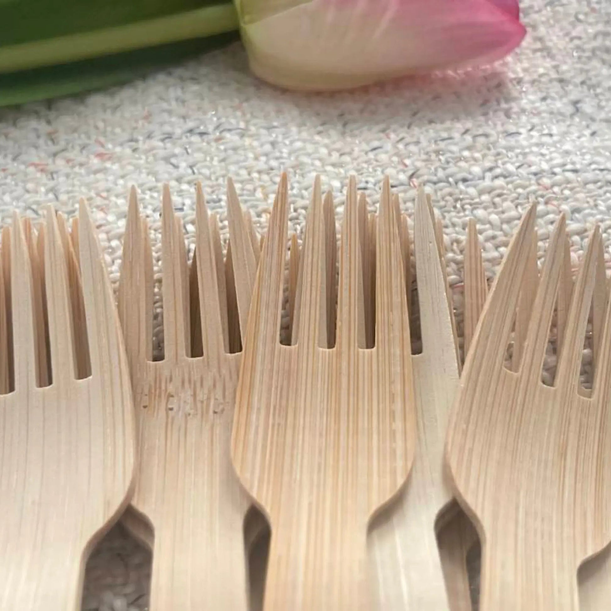 Six 6.7-inch bamboo forks from Holy City Straw Company disposable cutlery set, eco-friendly and natural in appearance.
