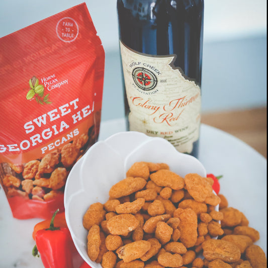 Two ounces of Sweet Georgia Heat sweet and spicy pecans by Horne Pecan Company, shown in a clear package.
