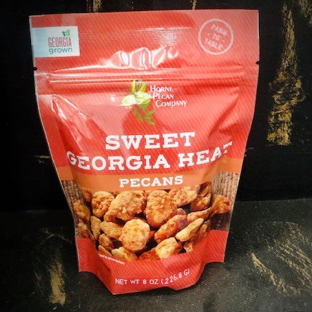 Two-ounce bag of Sweet Georgia Heat sweet and spicy pecans by Horne Pecan Company, showing glazed pecans in a clear bag