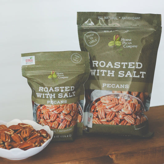 Roasted and salted pecans from Horne Pecan Company in an 8 oz package, showing golden-brown pecans with salt crystals