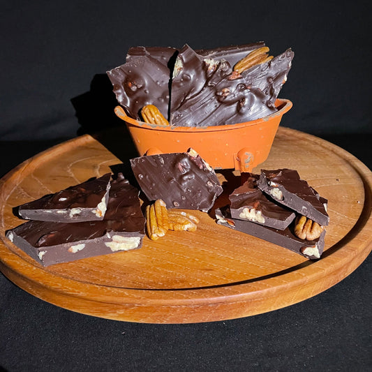 Dark chocolate pecan bark from Horne Pecan Company, 8 oz, with visible pecan pieces on rich chocolate surface.