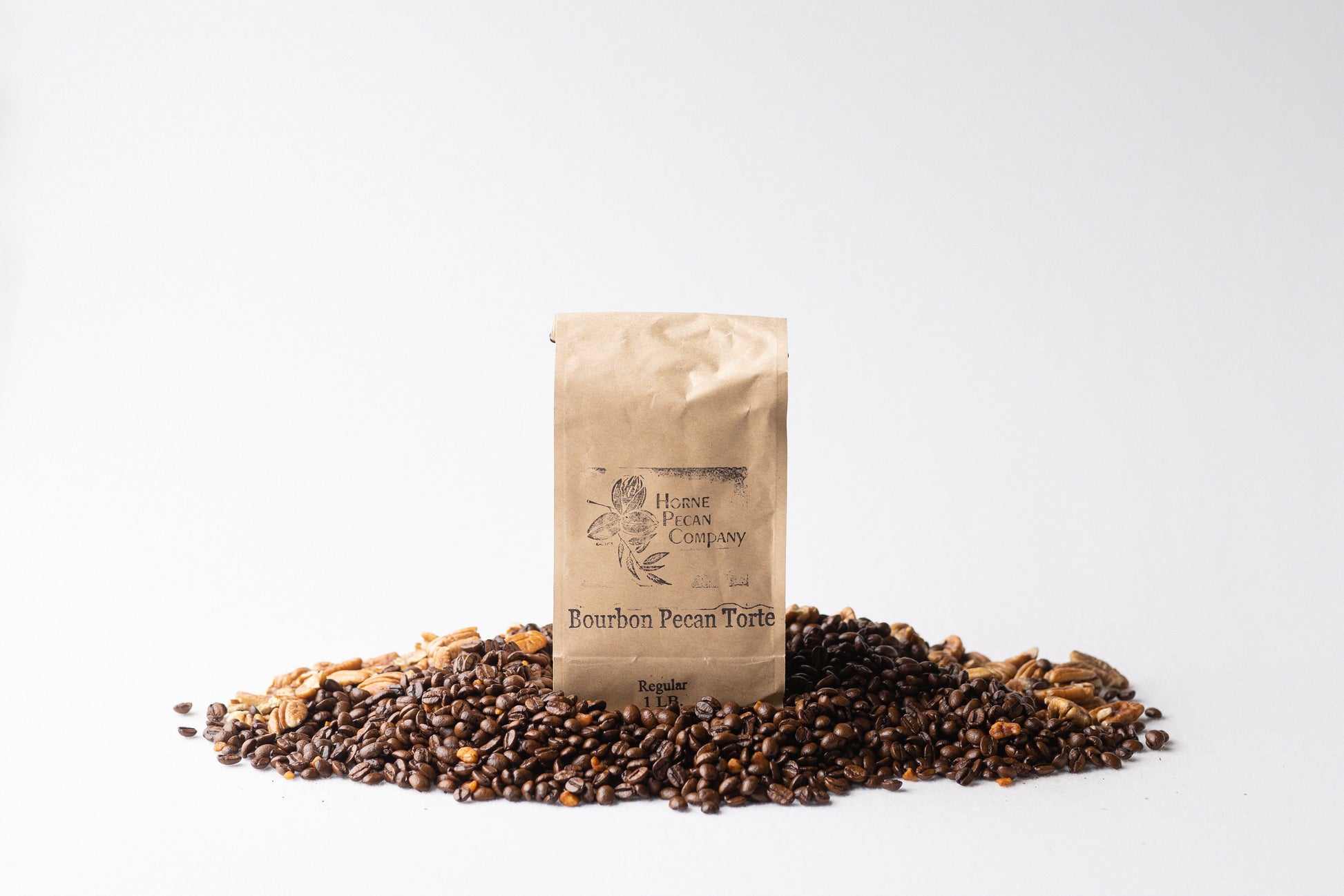 Ground gourmet pecan flavored coffee by Horne Pecan Company in a 1 lb bag, featuring rich pecan and bourbon notes.