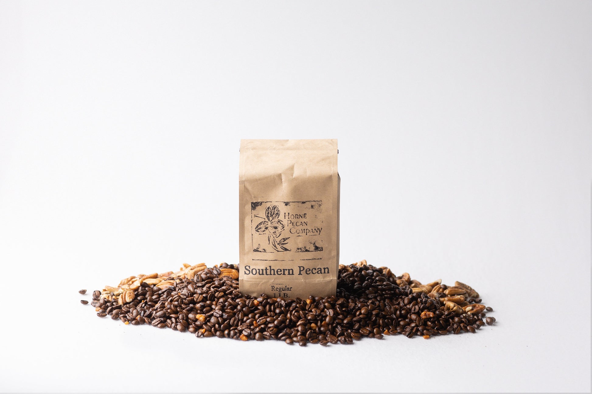 Horne Pecan Company gourmet pecan flavored coffee whole beans in a 1 lb bag, with rich coffee and pecan aroma visible in the image.
