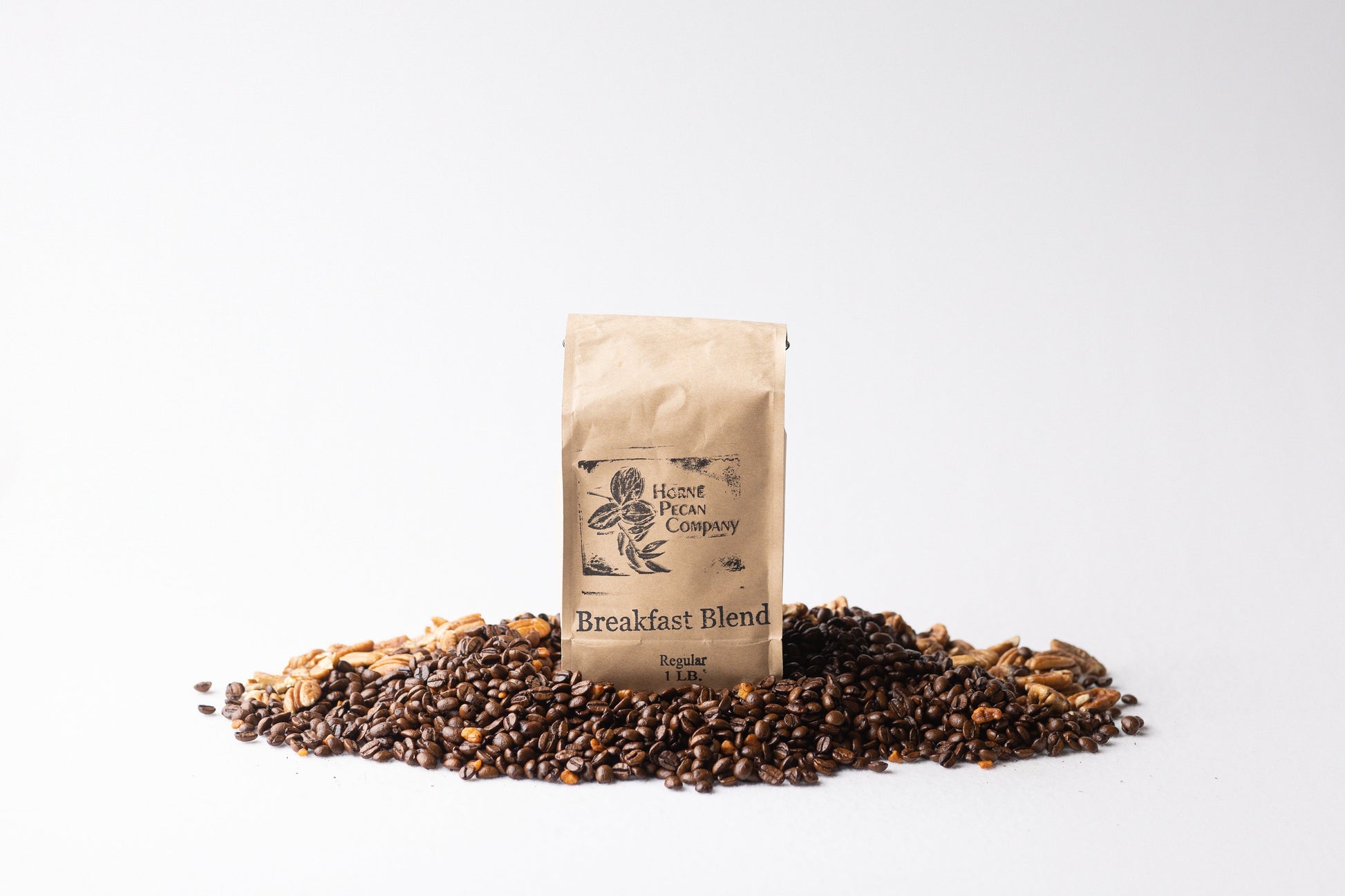 Horne Pecan Company gourmet pecan-flavored coffee in 1 lb. whole bean bag, rich coffee beans infused with pecan flavor.