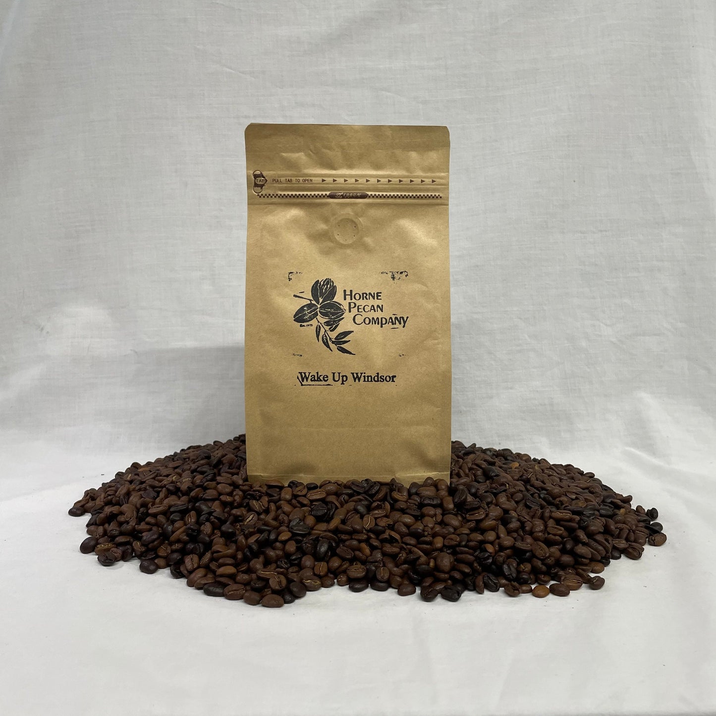 Horne Pecan Company gourmet pecan flavored coffee whole beans in a 1 lb bag with bourbon pecan aroma and rich coffee flavor.
