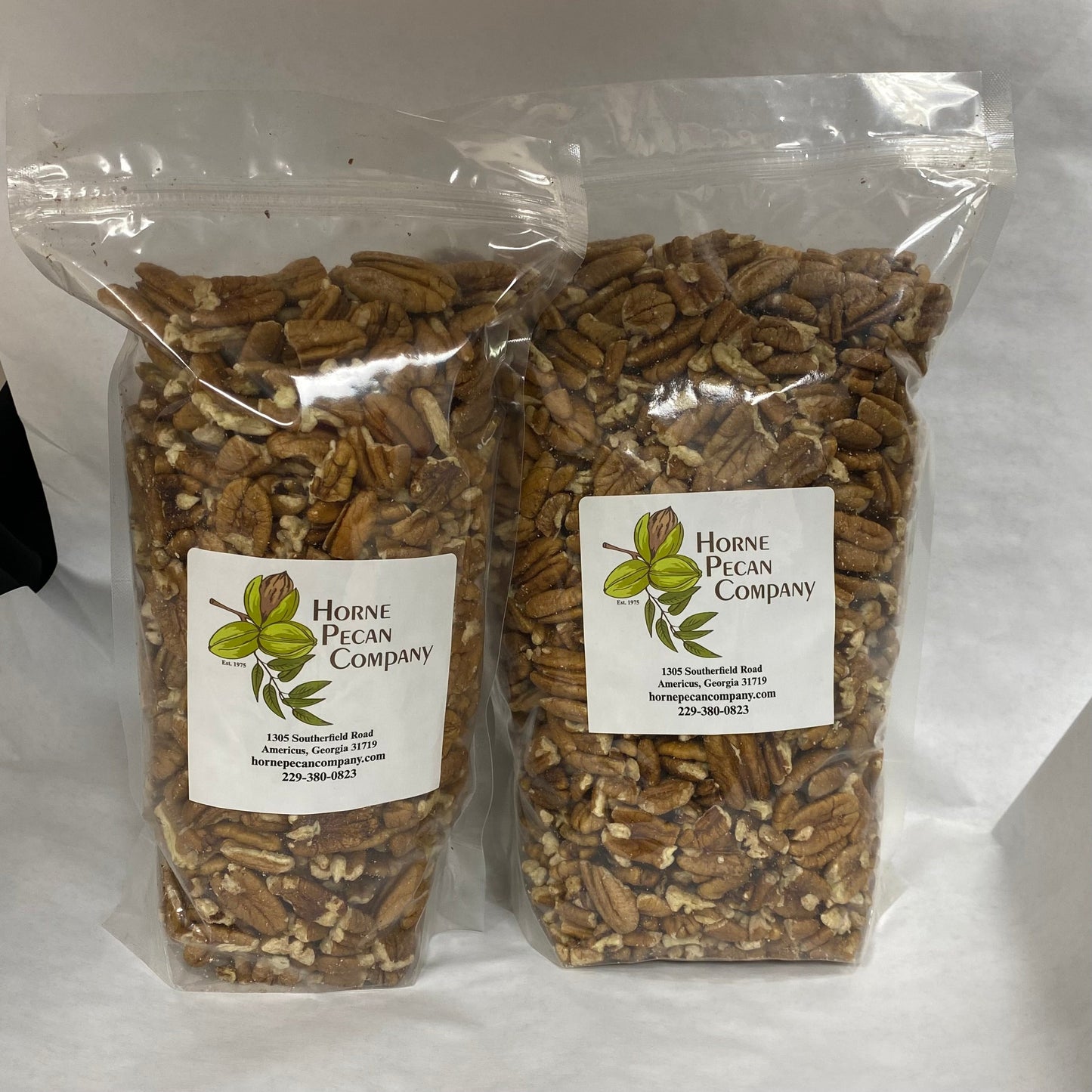 Bulk pecans from Horne Pecan Company, 2lb, 4lb, or 30lb, showing whole and halved pecans in a clear container.