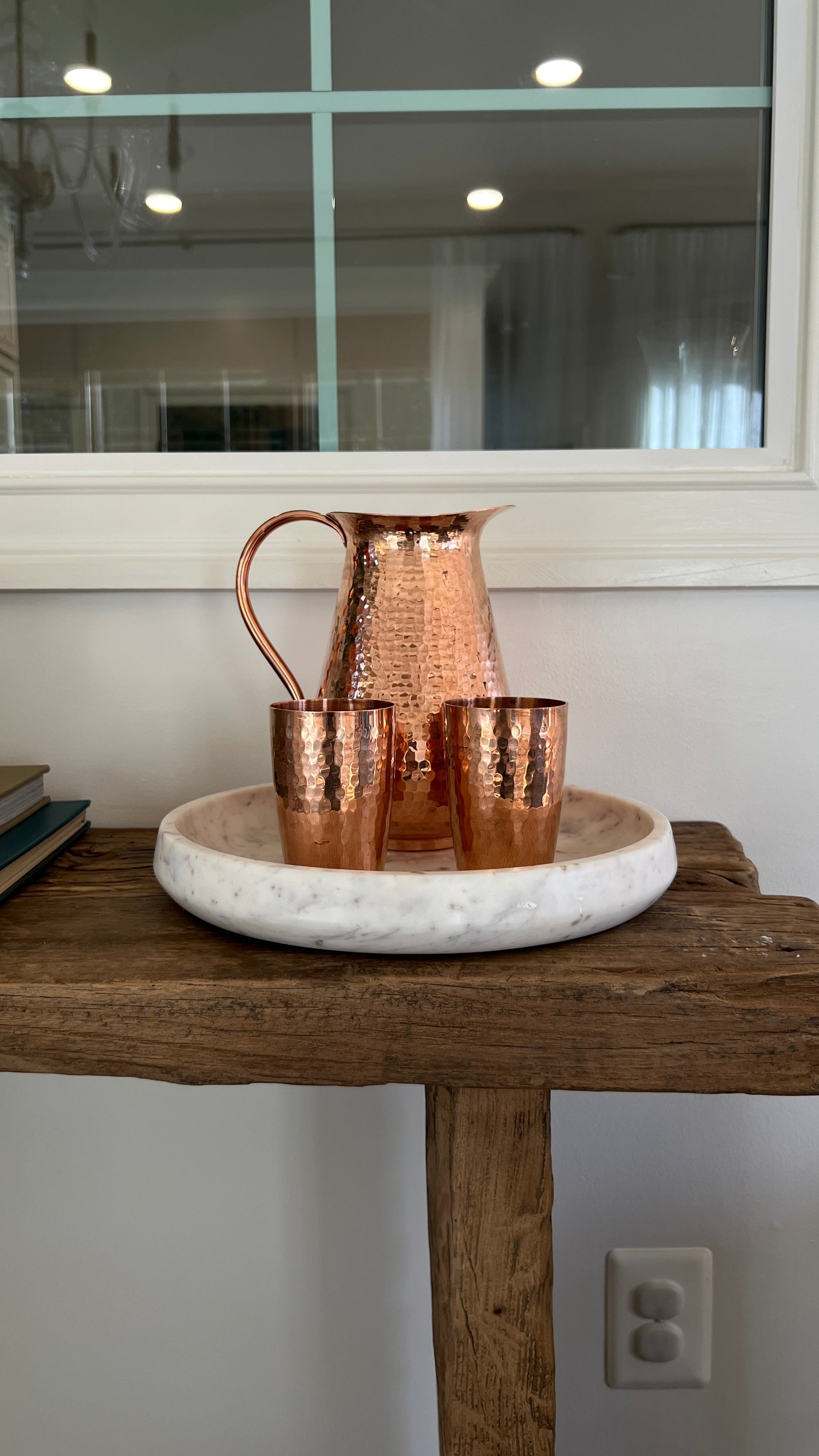 Sertodo Bisotun copper water pitcher with matching cups, handcrafted and polished, showcasing traditional design and bright copper finish.