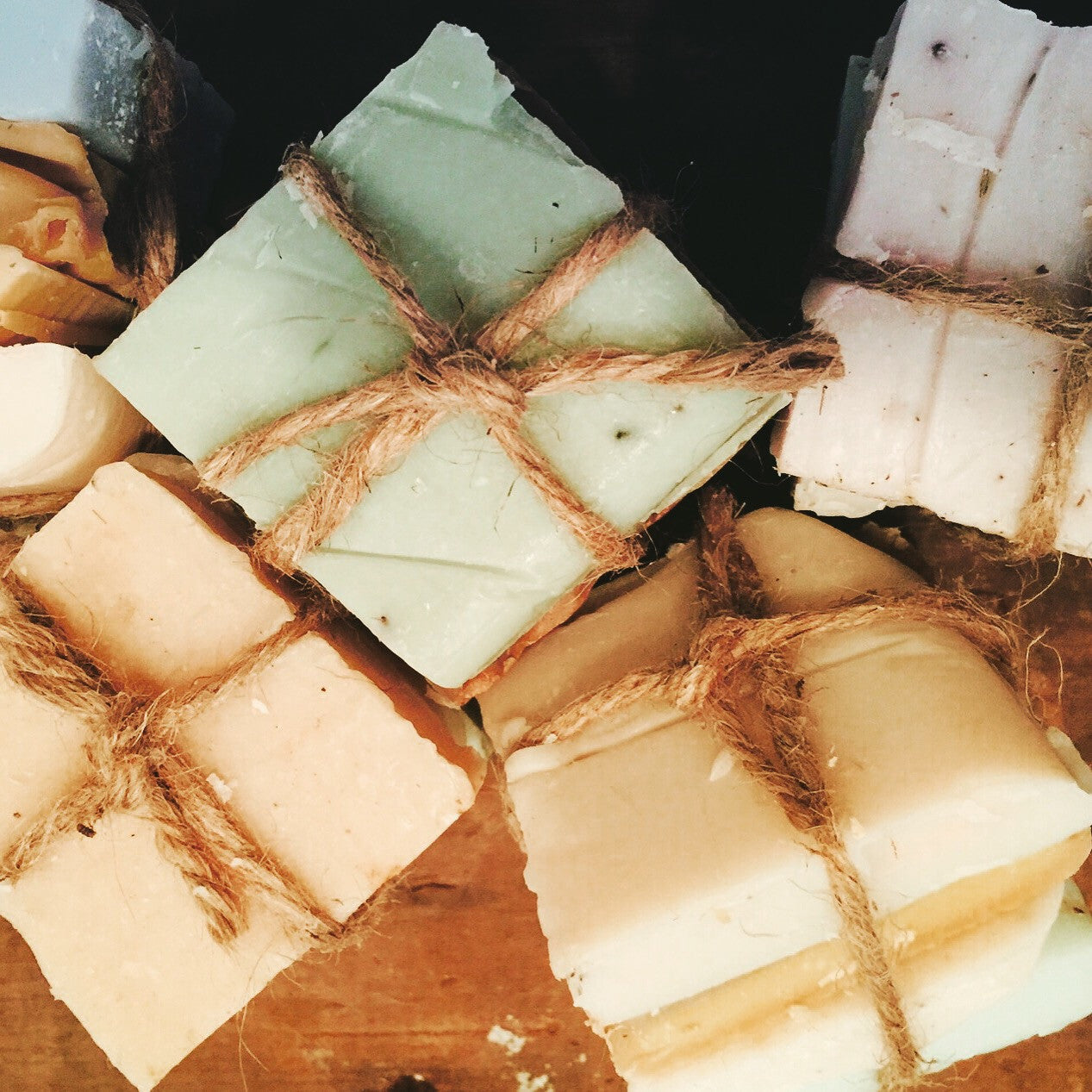Organic handmade mini soap bars in a travel pack by Sweet Harvest Farms, featuring natural soap textures and small, eco-friendly sizes.