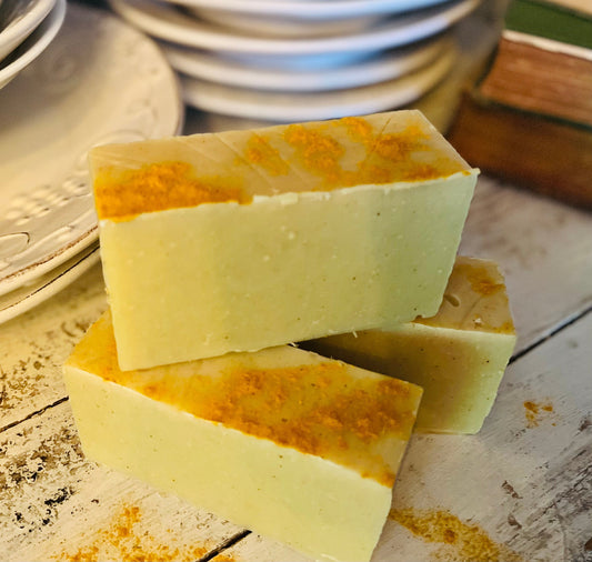 Turmeric handmade organic soap from Sweet Harvest Farms with a natural, textured appearance in a rustic soap bar.