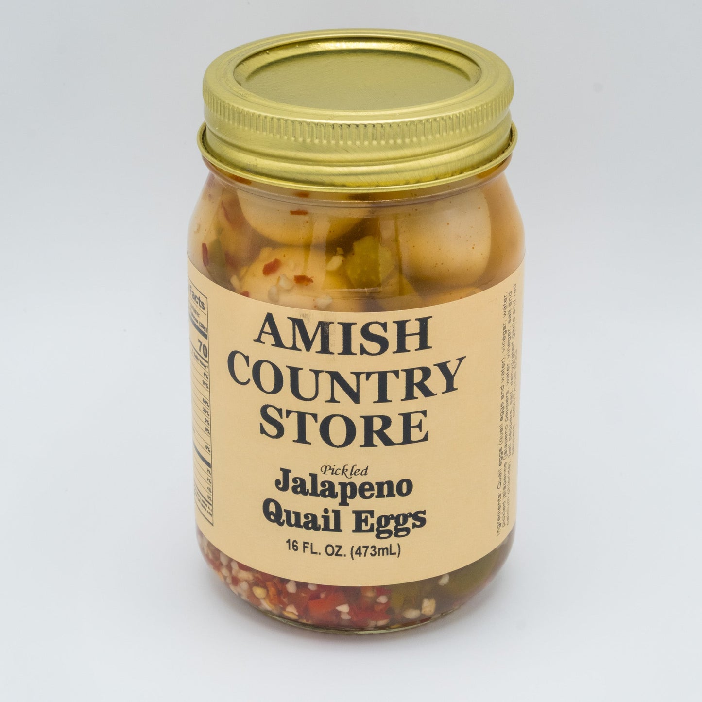 Canned Pickled Jalapeño Quail Eggs from Amish Country Store in a glass jar with vibrant jalapeños and eggs visible inside.