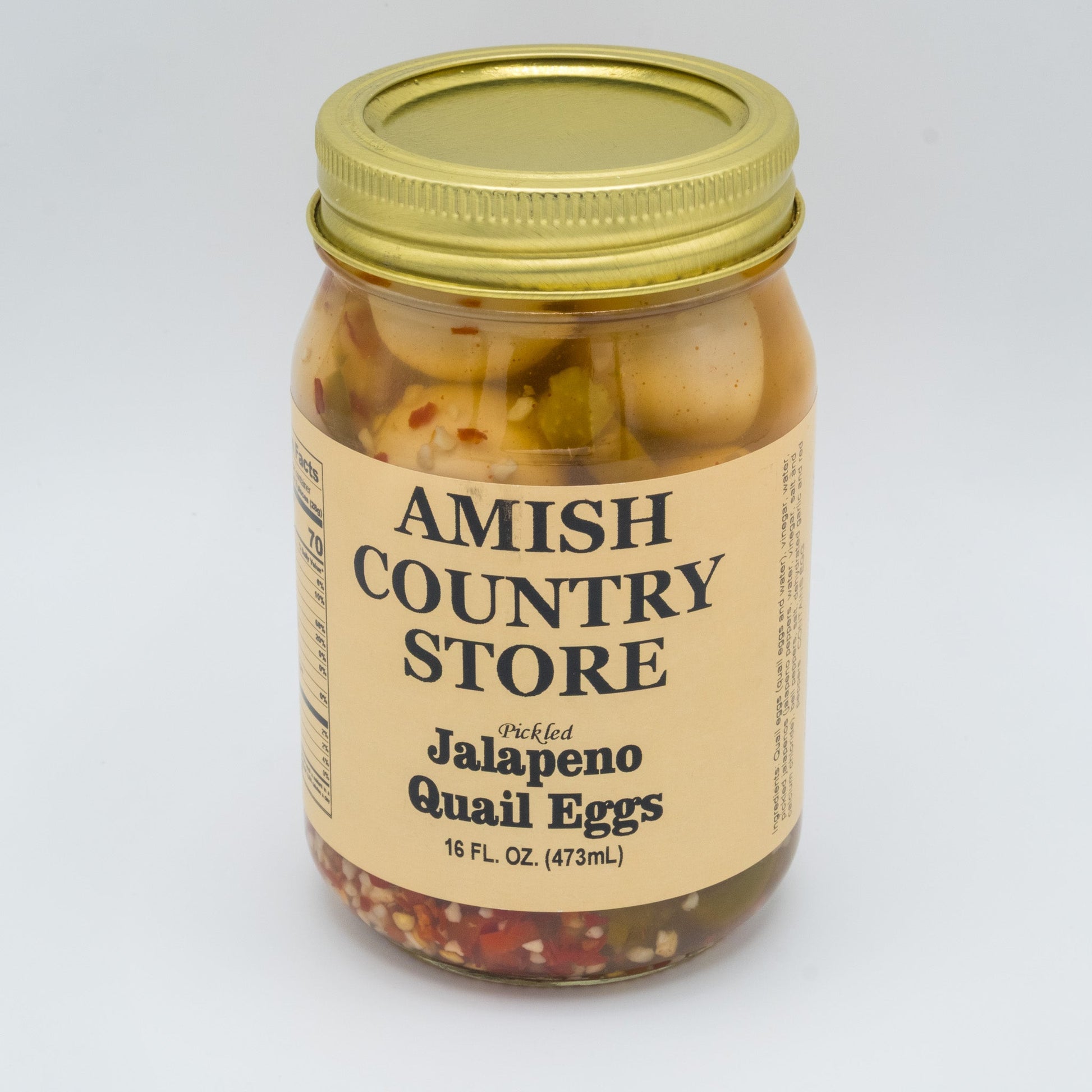 Canned Pickled Jalapeño Quail Eggs from Amish Country Store in a glass jar with vibrant jalapeños and eggs visible inside.