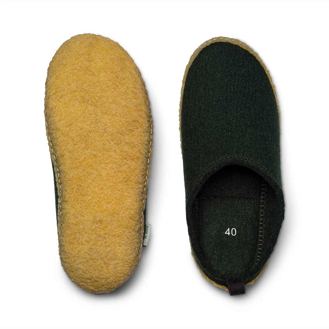 Kyrgies outdoor wool slides showing comfortable wool-lined slip-on footwear with outdoor sole in natural setting.