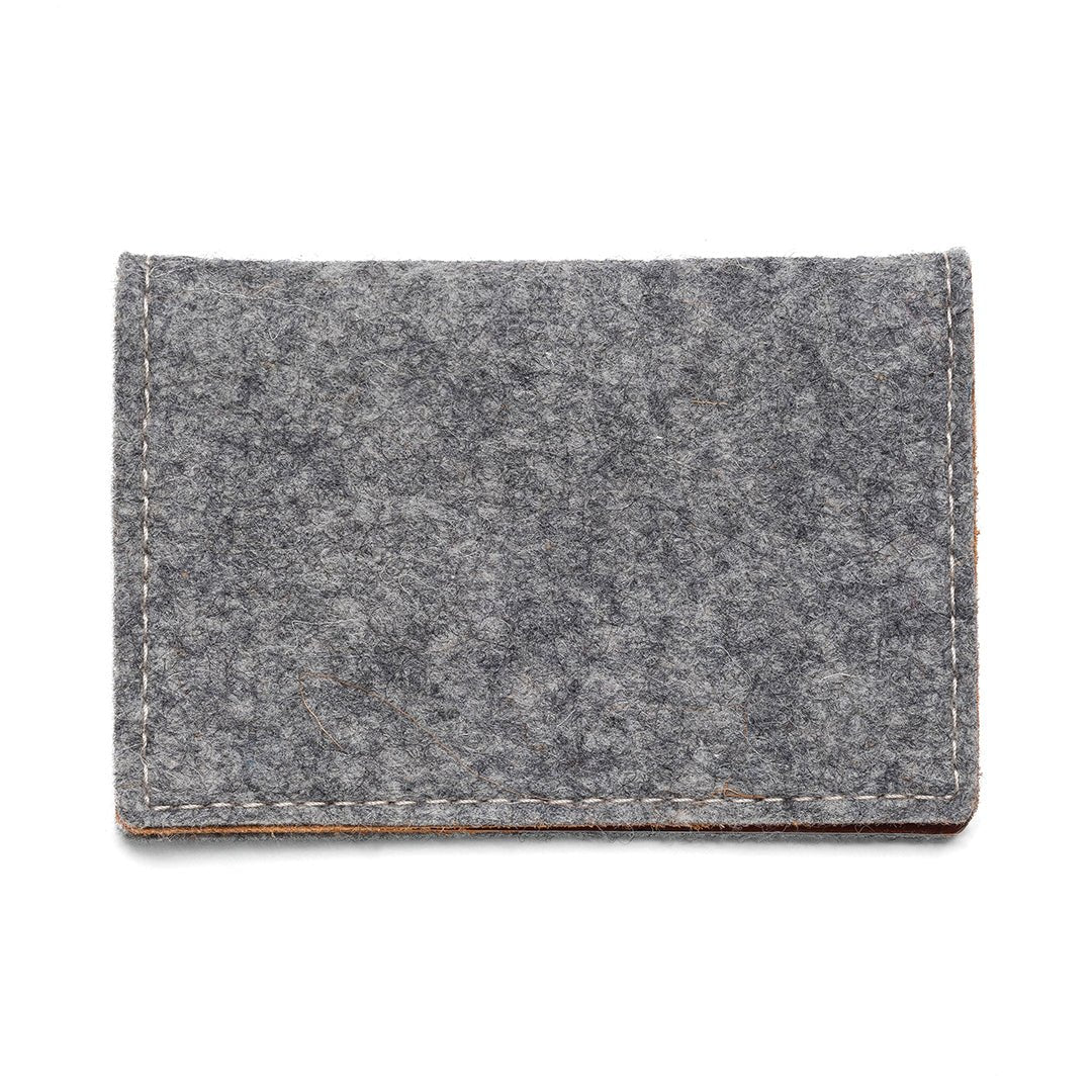 Gray felt and leather bifold wallet by Kyrgies, showing textured exterior and open interior with card slots.
