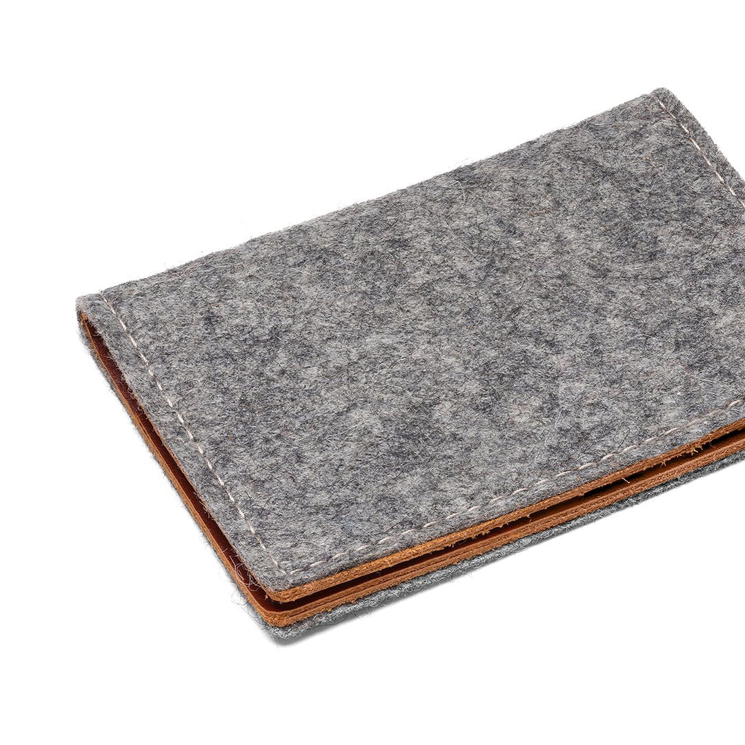 Gray felt and leather bifold wallet by Kyrgies, featuring multiple card slots and a sleek, minimalist design.