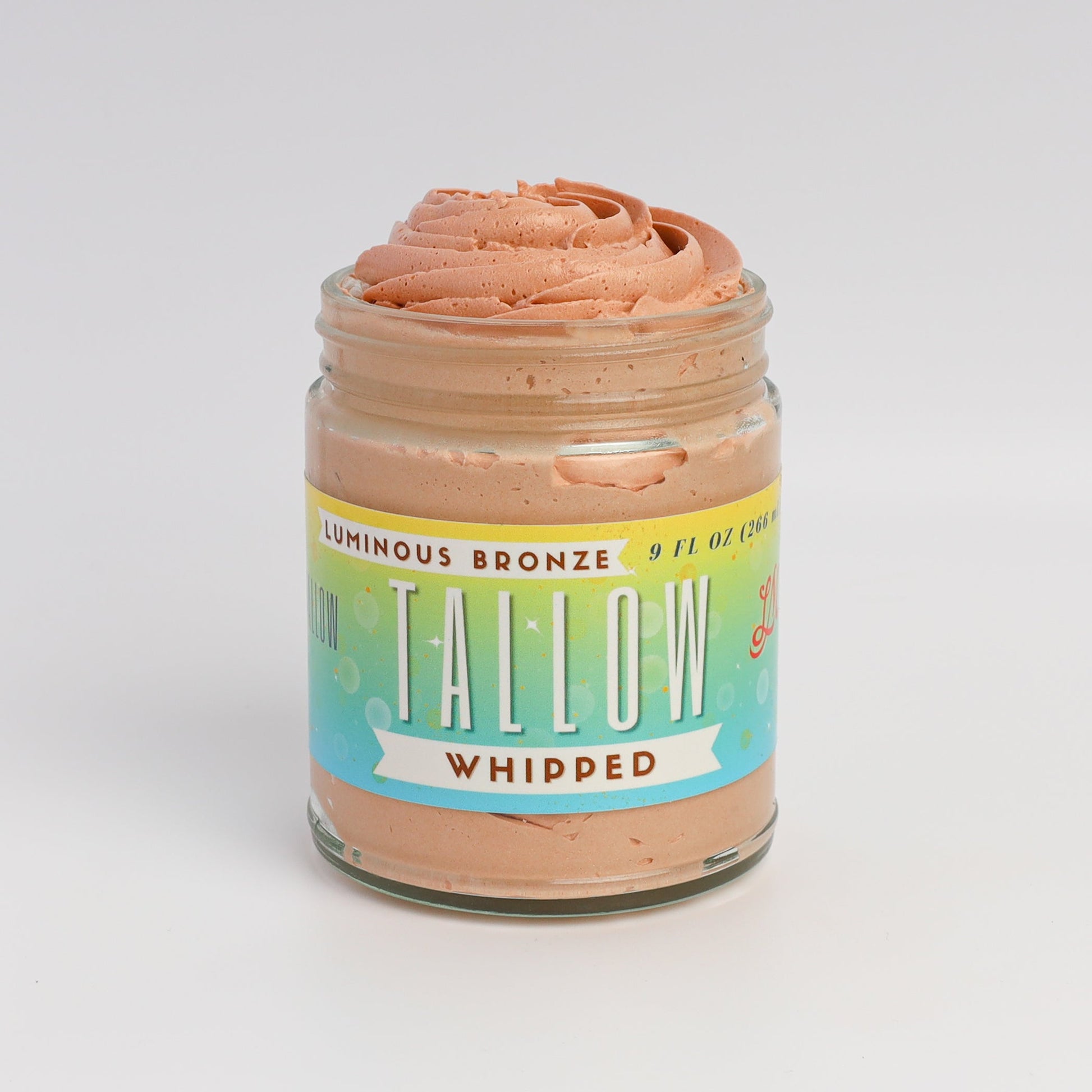 Luminous Bronze Whipped Tallow Moisturizer bronzer in a 9 oz jar, Lady May Tallow body cream with a smooth, glowing finish.