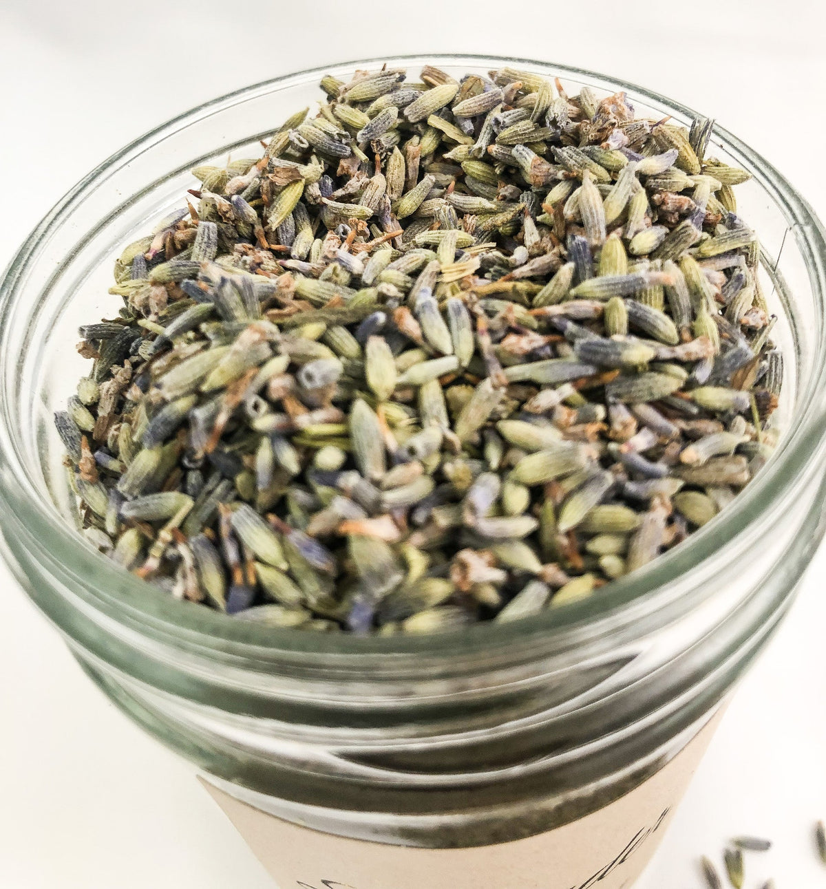 Small white jar of dried lavender herbs in a herbalroseapothecary herb jar for herbal remedies and aromatic use.