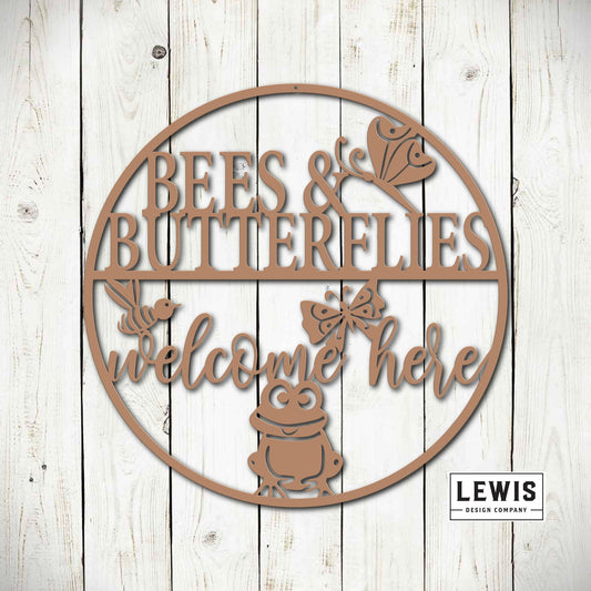 Black metal garden sign with bees and butterflies, saying "Welcome Here," outdoor patio and garden art by Lewis Design Company.