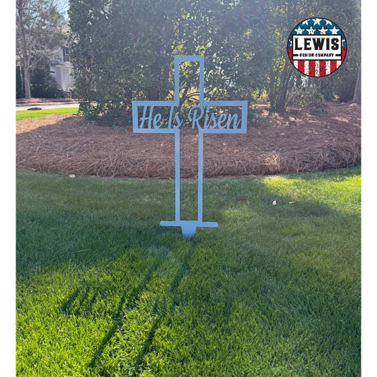 Pastel blue He Is Risen cross metal yard and garden sign by Lewis Design Company, outdoor Easter patio and garden art.