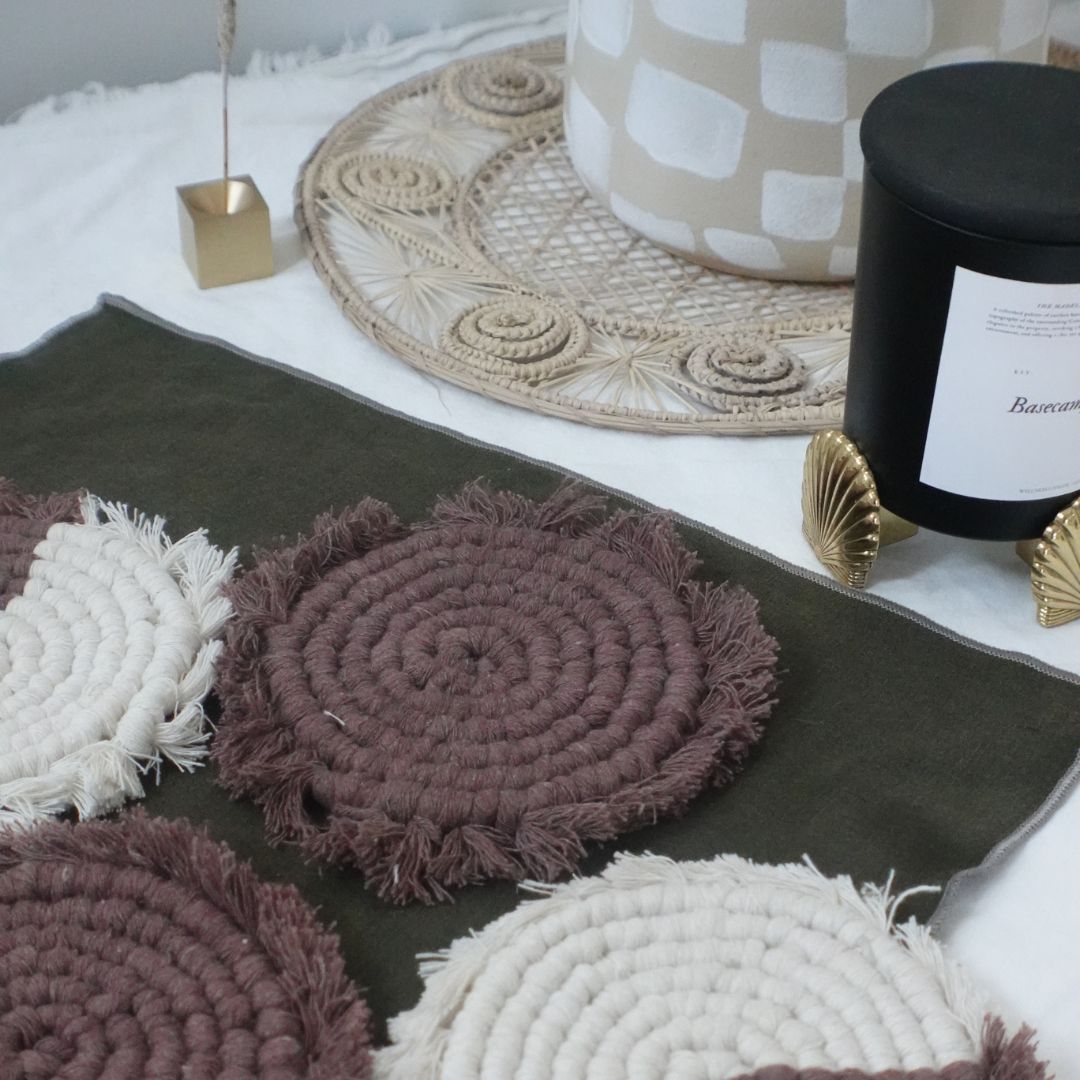 Set of four handmade macrame coasters by Tilley + Me, boho-style table decor with intricate knotted patterns for drink protection.