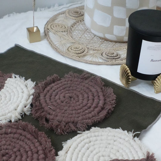 Set of four handmade macrame coasters with boho-style knots, perfect as table decor drink mats by Tilley + Me.