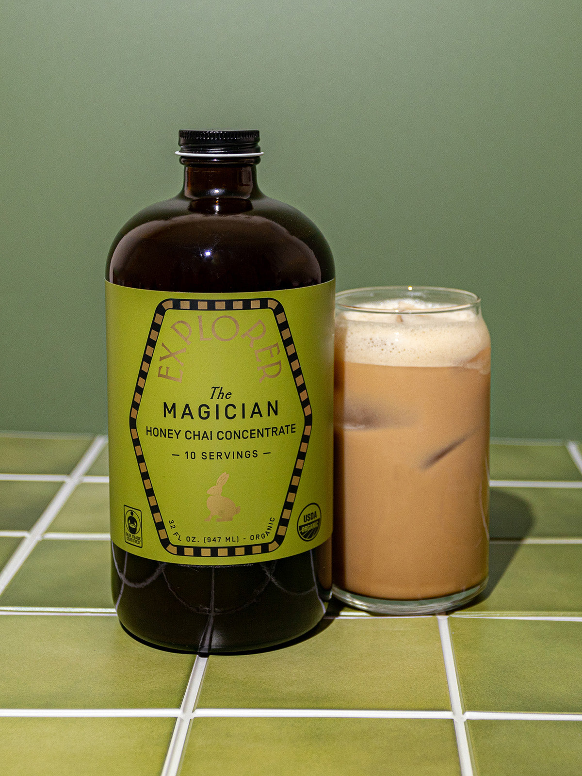 32oz Explorer Cold Brew Chai Concentrate bottle with Magician branding, showcasing the tea infusion product in a clear container.