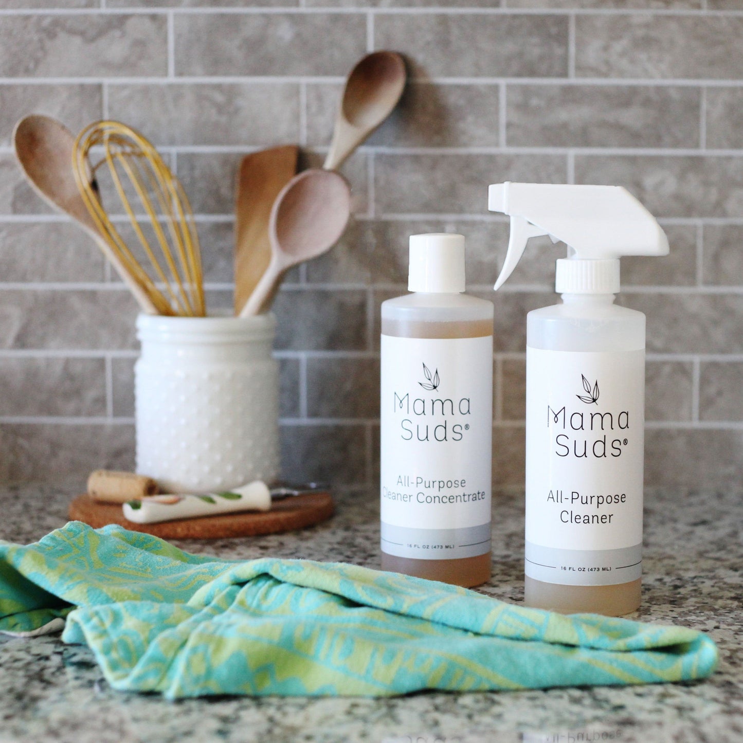 MamaSuds all-purpose cleaner concentrate in a clear bottle, ideal for household cleaning tasks and versatile surface use.