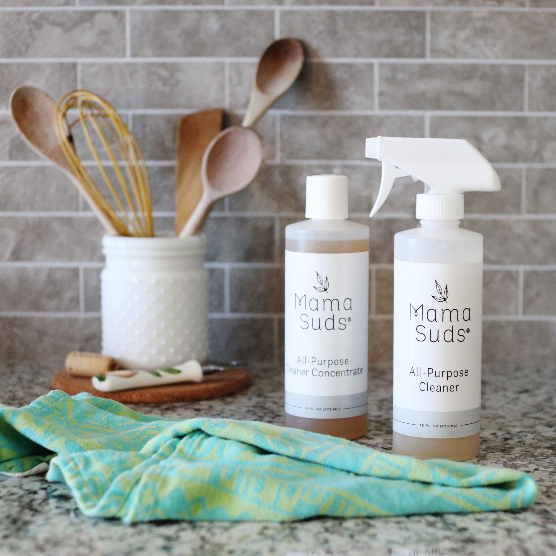 MamaSuds all-purpose cleaner concentrate in a clear bottle, ideal for household cleaning tasks and versatile surface use.