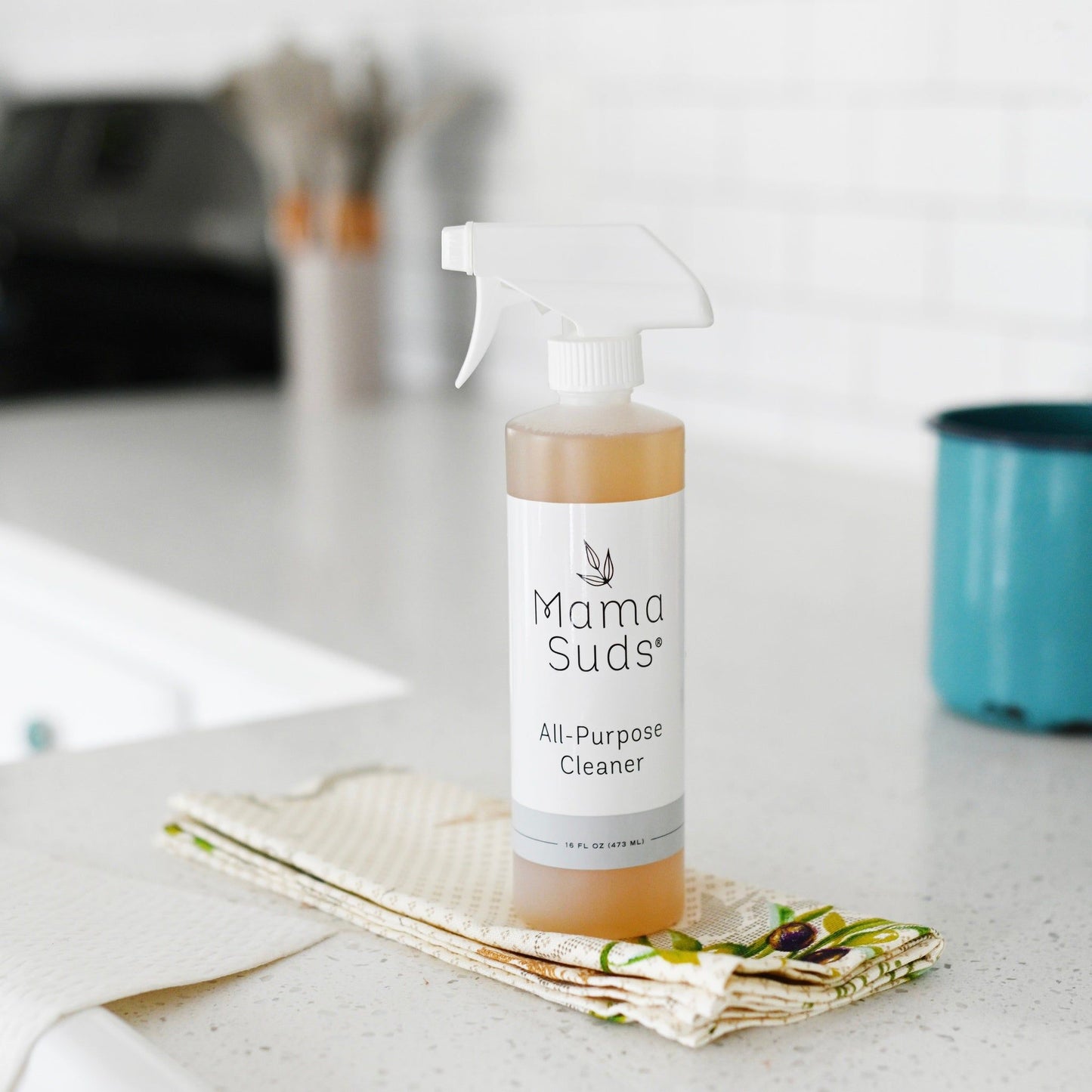 MamaSuds all-purpose cleaner spray for household cleaning, featuring a spray bottle with a green label and trigger nozzle.