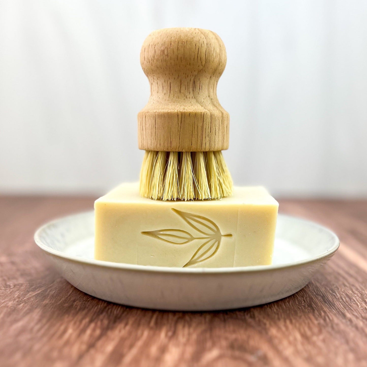 MamaSuds solid dish soap bar, natural household cleaning product with eco-friendly ingredients, shown on a clean kitchen surface.