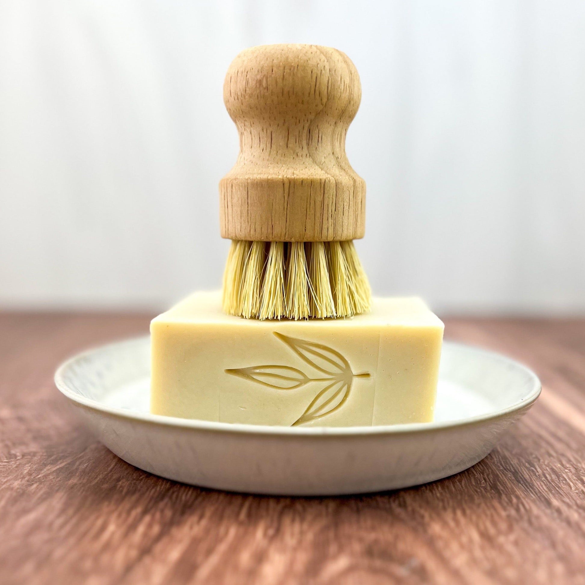 MamaSuds solid dish soap bar, natural household cleaning product with eco-friendly ingredients, shown on a clean kitchen surface.