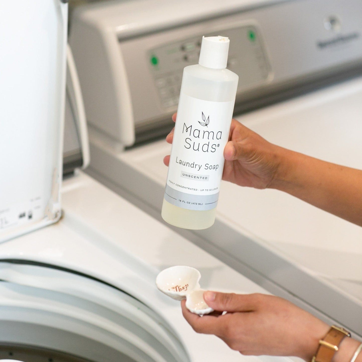 Unlabeled unscented MamaSuds laundry detergent soap in a 64-ounce bottle, household cleaning product for laundry.