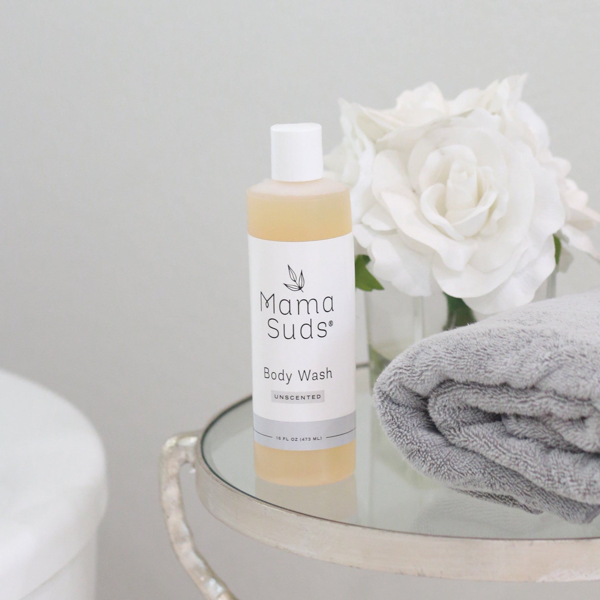 Unscented MamaSuds body wash soap in a clear bottle, designed for gentle household cleaning and skin care.