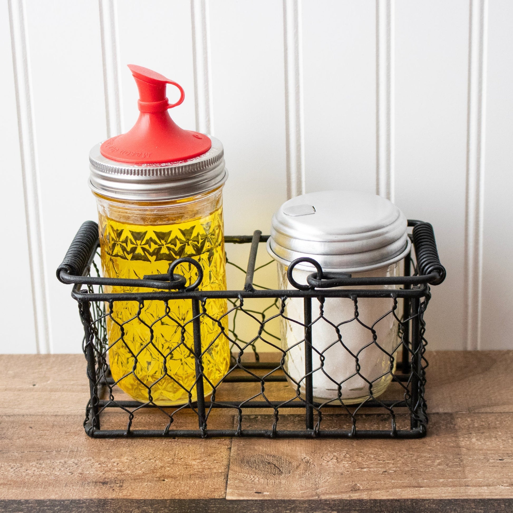 Chicken wire caddy holding two 8oz half-pint Mason jars from Mason Jar Lifestyle, with a rustic wire design.