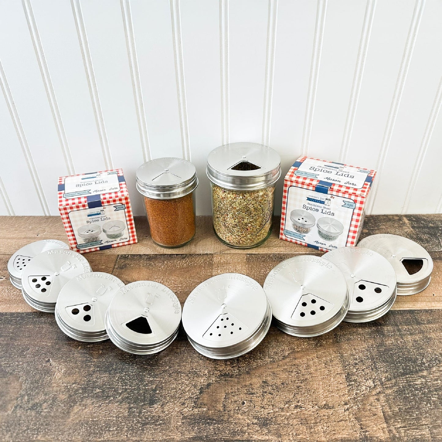 Set of four Mason Jar Lifestyle stainless steel spice shaker lids for mason jars, designed for regular-mouth jars in a home and garden setting.
