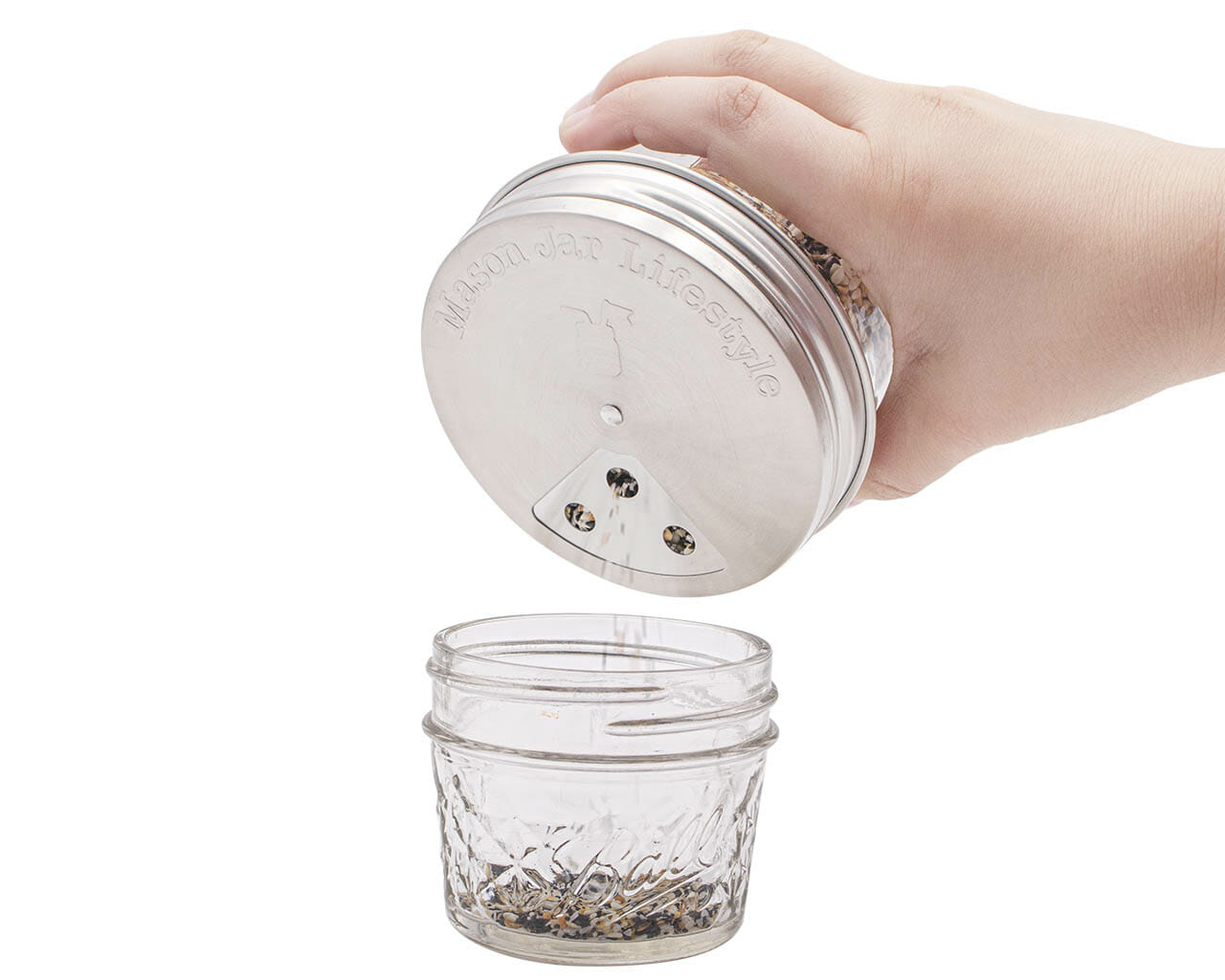 Set of four stainless steel spice shaker lids for Mason jars, compatible with regular-mouth mason jars for home kitchen use.