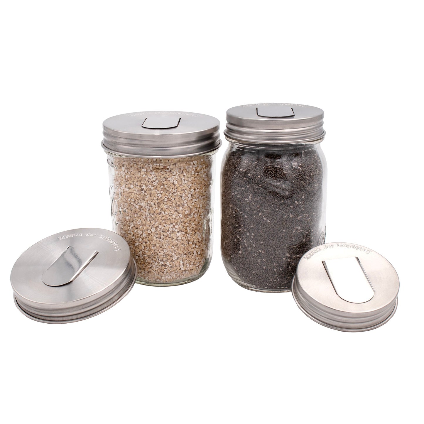 Two stainless steel lids for mason jars with grain dispensers, designed for regular-mouth jars, by Mason Jar Lifestyle.